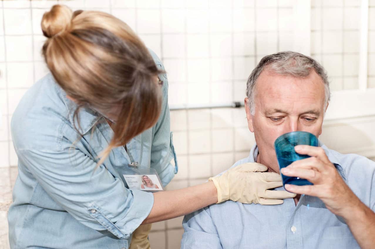 nurse giving man water