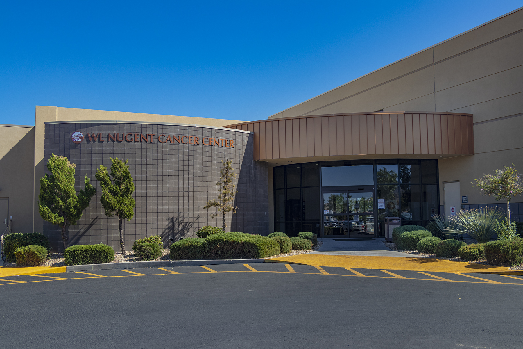 A building labeled "WL Nugent Cancer Center" stands before a blue sky  background 