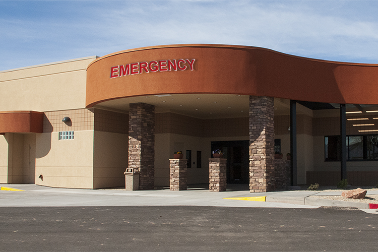 Entrance to a building with signage that reads "emergency"