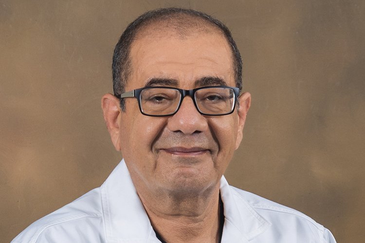 A portrait of Dr. Shehata before a tan/brown background
