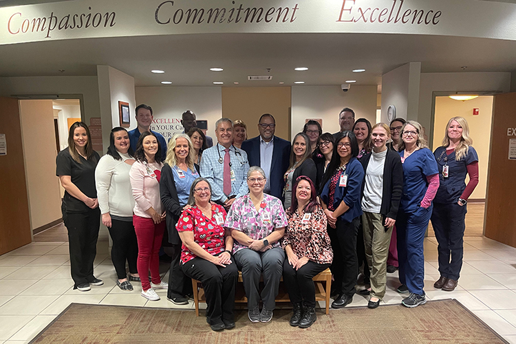 Physicians and staff of the WL Nugent Cancer Center pose together in the building's lobby 