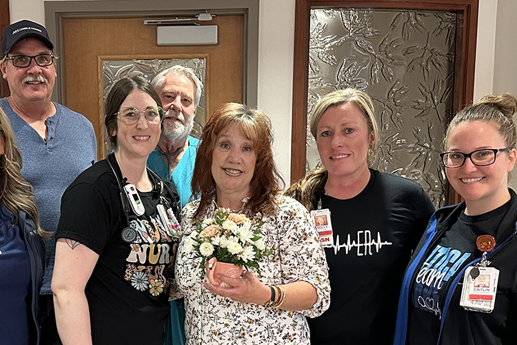 Kim stands with KRMC doctors, nurses, and her husband, Phil