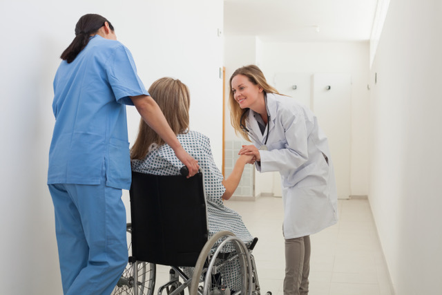 doctor talking to patient in wheelchair