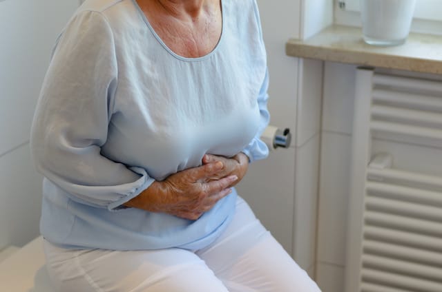 woman holding abdomen