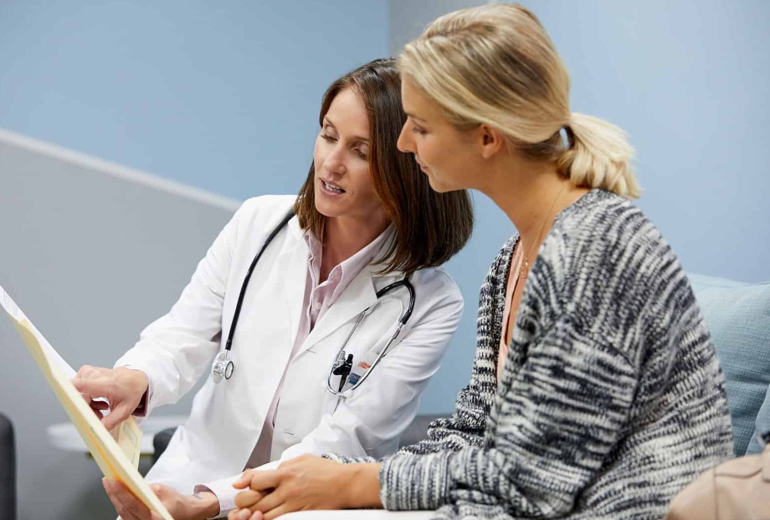 doctor showing woman papers