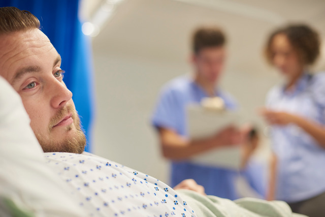 man in hospital bed