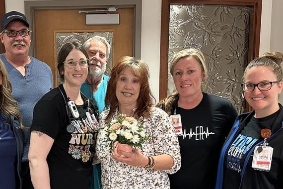 Kim stands with KRMC doctors, nurses, and her husband, Phil